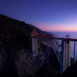 Preview wallpaper bridge, sea, cliff, lights, night, sky, long exposure