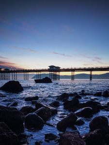 Preview wallpaper bridge, sea, rocks, twilight