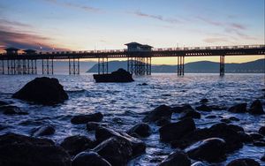 Preview wallpaper bridge, sea, rocks, twilight