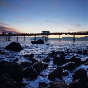 Preview wallpaper bridge, sea, rocks, twilight