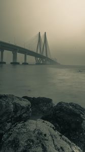 Preview wallpaper bridge, stones, fog, sea, black and white