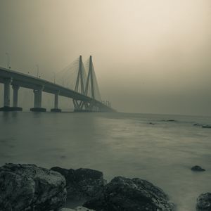 Preview wallpaper bridge, stones, fog, sea, black and white