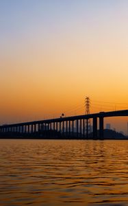 Preview wallpaper bridge, water, sunset, waves, dusk