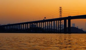 Preview wallpaper bridge, water, sunset, waves, dusk