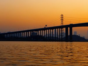 Preview wallpaper bridge, water, sunset, waves, dusk