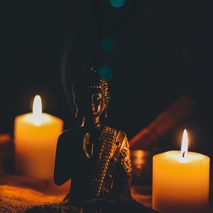Preview wallpaper buddha, figurine, candles, buddhism, harmony