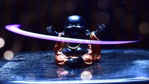 Preview wallpaper buddha, statuette, light, glare, bokeh