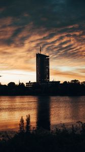 Preview wallpaper building, apartments, silhouette, sunset, river