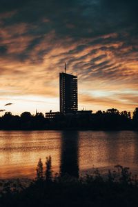 Preview wallpaper building, apartments, silhouette, sunset, river