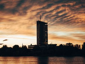 Preview wallpaper building, apartments, silhouette, sunset, river