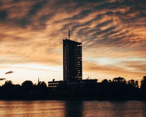 Preview wallpaper building, apartments, silhouette, sunset, river