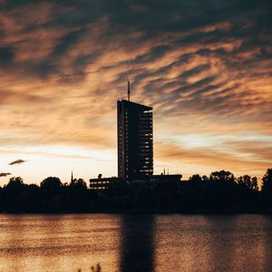 Preview wallpaper building, apartments, silhouette, sunset, river