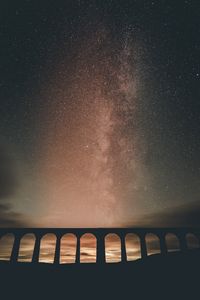 Preview wallpaper building, arch, nebula, stars, starry sky, night