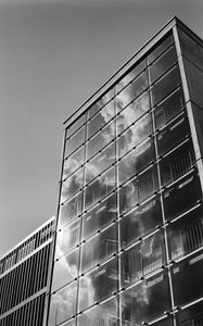 Preview wallpaper building, bars, glass, clouds, reflection, bw