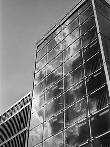 Preview wallpaper building, bars, glass, clouds, reflection, bw