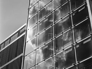 Preview wallpaper building, bars, glass, clouds, reflection, bw