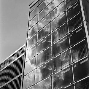 Preview wallpaper building, bars, glass, clouds, reflection, bw