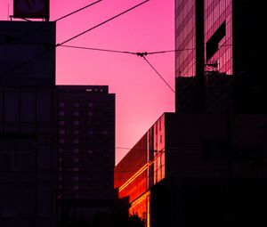 Preview wallpaper building, city, sunset, silhouette