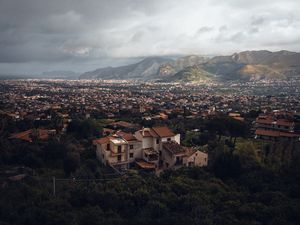 Preview wallpaper building, city, trees, mountains, distance