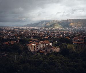 Preview wallpaper building, city, trees, mountains, distance