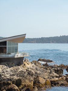 Preview wallpaper building, coast, rocks, stones, sea