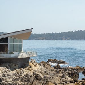 Preview wallpaper building, coast, rocks, stones, sea