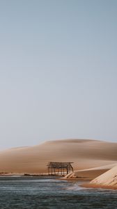 Preview wallpaper building, coast, sand, water, sky