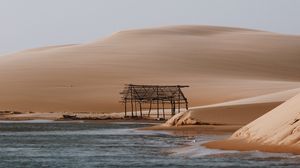 Preview wallpaper building, coast, sand, water, sky