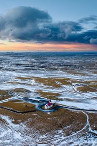 Preview wallpaper building, coast, snow, sea, aerial view