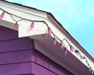 Preview wallpaper building, facade, roof, garland, purple