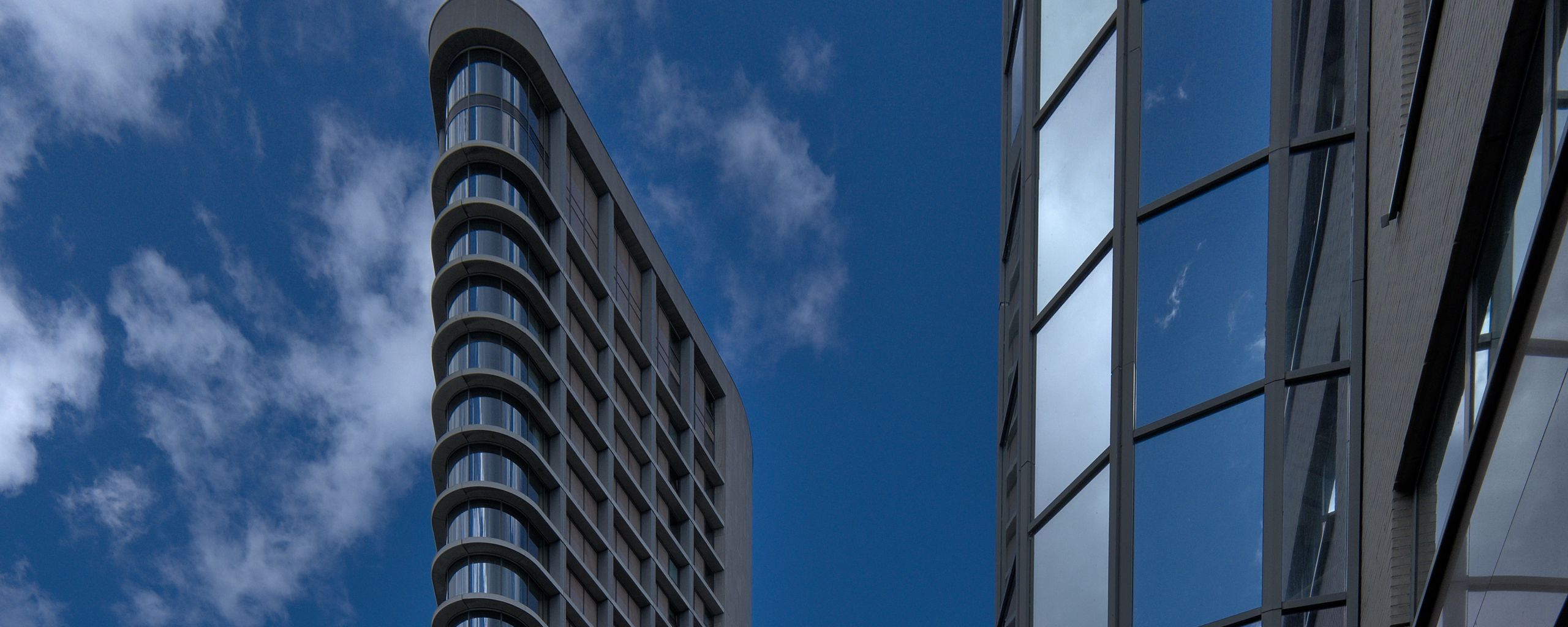 Download wallpaper 2560x1024 building, facade, windows, glass, sky