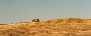 Preview wallpaper building, field, grass, hill, sky