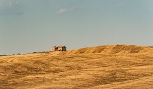 Preview wallpaper building, field, grass, hill, sky