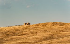 Preview wallpaper building, field, grass, hill, sky