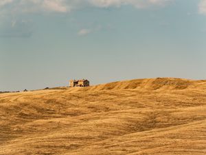 Preview wallpaper building, field, grass, hill, sky