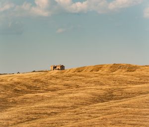 Preview wallpaper building, field, grass, hill, sky