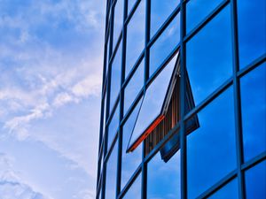 Preview wallpaper building, glass, mirror, window, sky, clouds, blue