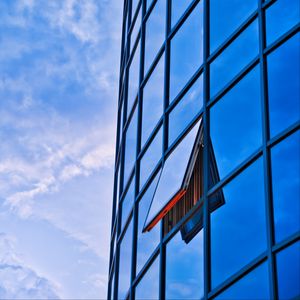 Preview wallpaper building, glass, mirror, window, sky, clouds, blue