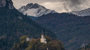 Preview wallpaper building, mountains, forest, trees, rocks