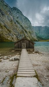 Preview wallpaper building, pier, rocks, mountains, lake