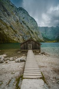 Preview wallpaper building, pier, rocks, mountains, lake