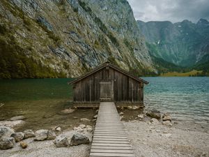 Preview wallpaper building, pier, rocks, mountains, lake