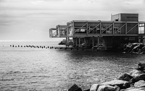 Preview wallpaper building, pilings, architecture, sea, black and white
