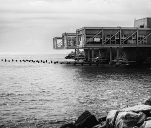 Preview wallpaper building, pilings, architecture, sea, black and white