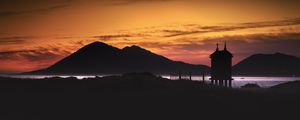 Preview wallpaper building, pilings, lake, mountains, silhouettes, evening