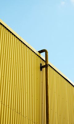 240x400 Wallpaper building, pipe, yellow, minimalism