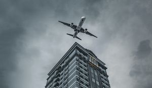 Preview wallpaper building, plane, sky, gray