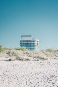 Preview wallpaper building, sand, dunes, grass, minimalism