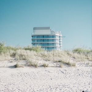 Preview wallpaper building, sand, dunes, grass, minimalism