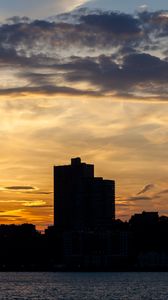 Preview wallpaper building, silhouette, sea, sunset, sky